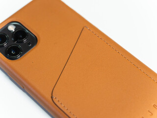 A brown smartphone case with a leather wallet pocket