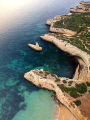 Drone view of the Yellow Submarine rock on the Algarve coast in Portugal, in Praia da Morena bay,...