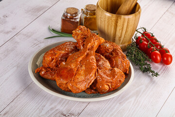 Raw turkey shoulder wing in Indian tandoori marinade