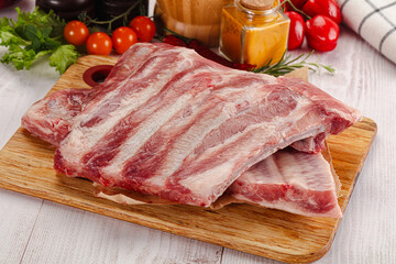 Raw pork ribs over board