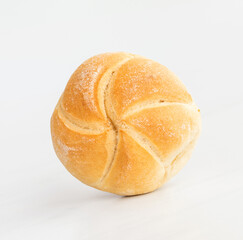 fresh baked roll (bun) on a white