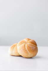 fresh baked roll (bun) on a white