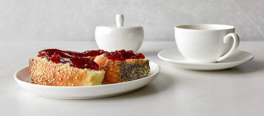 peaces of buns with jam and cup of tea