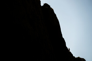 Silhouette of a climber on a steep rock. Mount Anica Kuk, Paklenica National Park, Croatia.