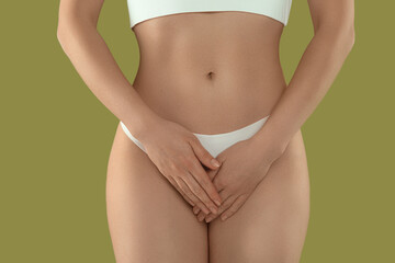 Gynecology. Woman in underwear on green background, closeup