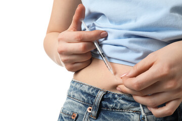 Diabetes. Woman making insulin injection into her belly on white background, closeup