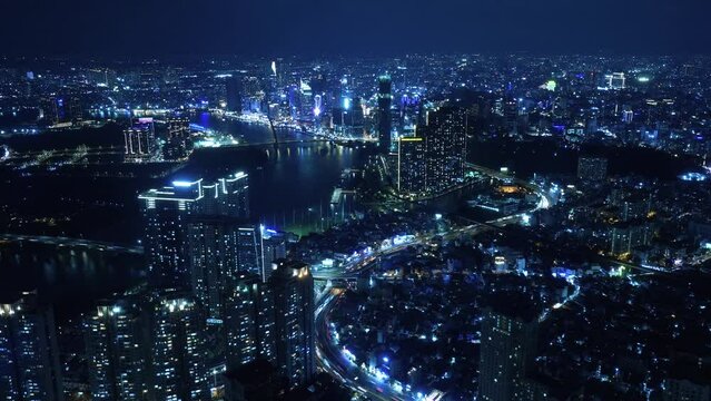 Nightlapse of Ho Chi Minh City, Saigon Vietnam at night with the view of the city center with bright lights and fast traffic timelapse