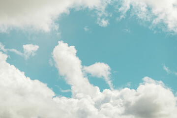 Serene blue sky with fluffy white clouds