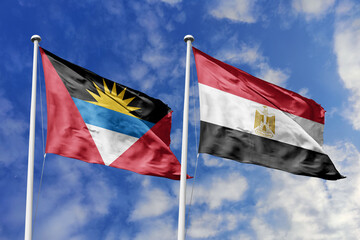  3d illustration. Antigua and Barbuda and Egypt Flag waving in sky. High detailed waving flag. 3D render. Waving in sky. Flags fluttered in the cloudy sky.