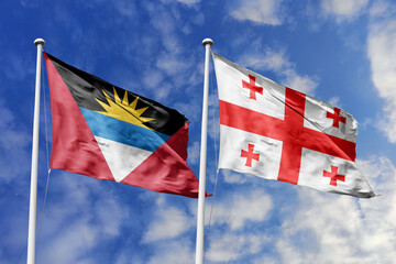  3d illustration. Antigua and Barbuda and Georgia Flag waving in sky. High detailed waving flag. 3D render. Waving in sky. Flags fluttered in the cloudy sky.