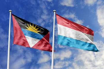  3d illustration. Antigua and Barbuda and Luxembourg Flag waving in sky. High detailed waving flag. 3D render. Waving in sky. Flags fluttered in the cloudy sky.