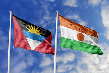 3d illustration. Antigua and Barbuda and Niger Flag waving in sky. High detailed waving flag. 3D render. Waving in sky. Flags fluttered in the cloudy sky.