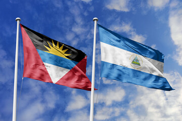 3d illustration. Antigua and Barbuda and Nicaragua Flag waving in sky. High detailed waving flag. 3D render. Waving in sky. Flags fluttered in the cloudy sky.