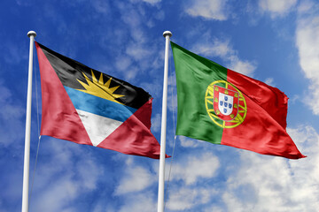 3d illustration. Antigua and Barbuda and Portugal Flag waving in sky. High detailed waving flag. 3D render. Waving in sky. Flags fluttered in the cloudy sky.