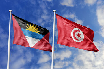 3d illustration. Antigua and Barbuda and Tunisia Flag waving in sky. High detailed waving flag. 3D render. Waving in sky. Flags fluttered in the cloudy sky.