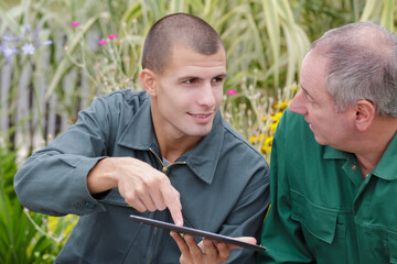 two agricultural engineers analyze data with tablet computer