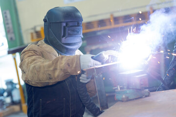 welding man welding pipe in industry
