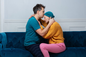 Man support wife in cancer fight, kiss her gently at forehead