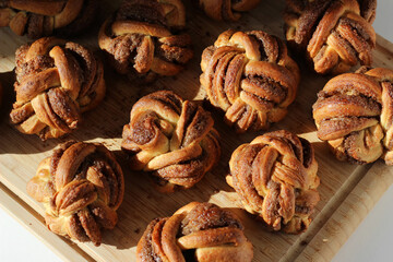 Homemade Cinnamon Buns. Freshly Baked Buttery Cinnamon Buns on Wooden Board. 