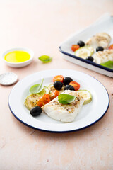 Roasted cod with olives, tomato and zucchini