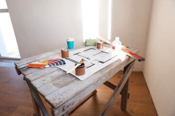 Plan of renovation of house on old wooden table. Top view.
