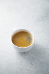 Black coffee served in a white cup