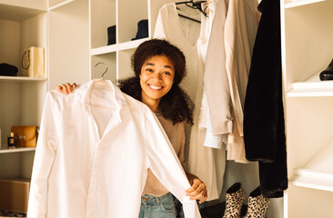 A close-up portrait of a young teenage girl of mixed race in a home dressing room
