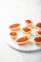 Red caviar served in tartlets