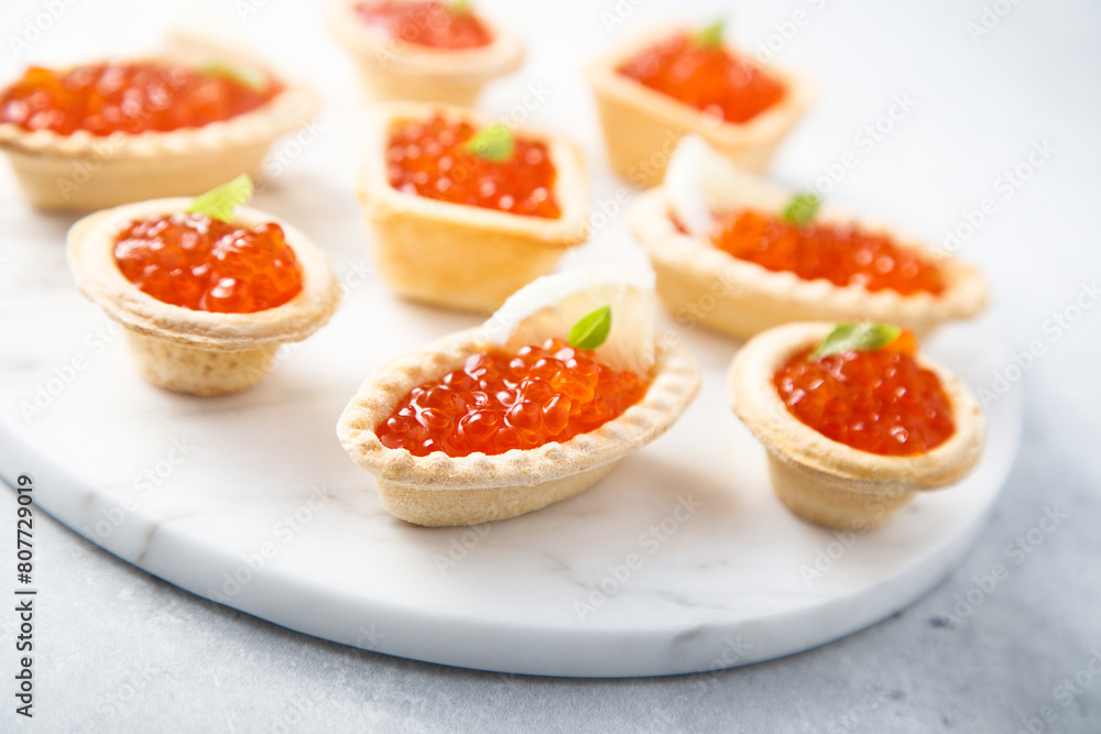 Poster red caviar served in tartlets