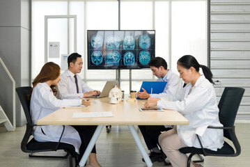Group of medical professional engaged in a discussion or meeting in a medical office. A large...