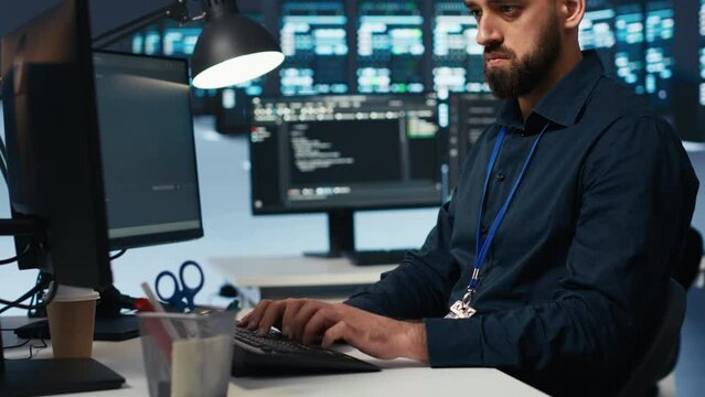 Proficient technician overseeing server room, running code on computer, troubleshooting servers. Software developer upgrading hardware clusters, networking systems and storage arrays