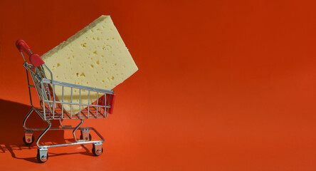 The cheese is in the shopping cart. selling food in the store. background for the design. dairy...