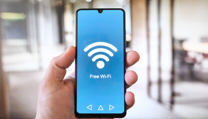 Free Wi-Fi Alert. White male hand in front of office background. 