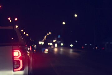 Abstract and blurred view of picture car in city at night. Turn on brake light with lighting of...