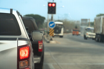 Pickup car silver color on the road stop and turn on brake light. Traffic light on the road. Blur image of traffic jam.