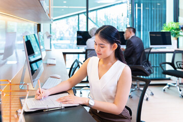 Asian businesswoman in formal suit working in modern luxury office using computer for business and education concept