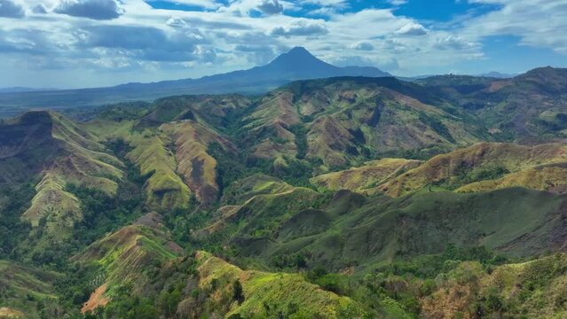 Green Landscape of Philippines and green plants during sunny day. Large Matutum Mountain Volcano in background. Panorama view.