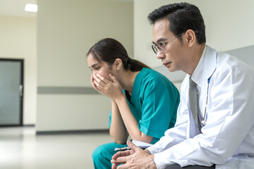 Obraz premium Asian male doctor and female nurse working in hospital