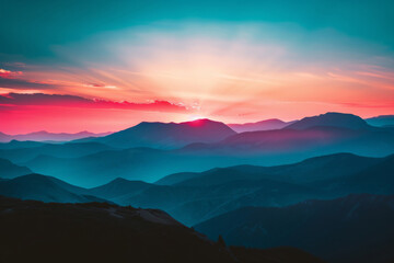 Obraz premium Tranquil and majestic mountain sunset casting vibrant orange, pink, blue, and golden colors over the ethereal wilderness landscape