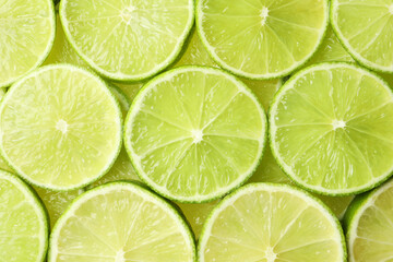 Fototapeta na wymiar Fresh juicy lime slices as background, top view