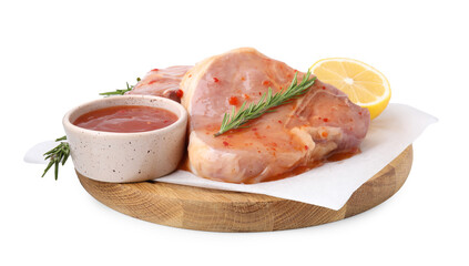 Board with raw meat, marinade, lemon and rosemary isolated on white