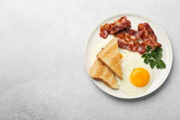Delicious breakfast with sunny side up egg on light table, top view. Space for text