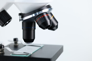 Modern microscope on light background, closeup view