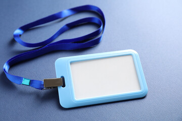 Blank badge with string on blue background, closeup