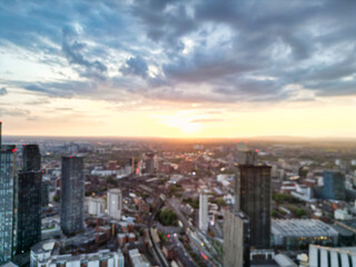 Naklejka na ściany i meble Aerial View of Great Manchester City Centre and Tall Buildings During Golden Hour of Sunset. May 5th, 2024