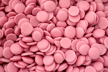 pink chocolate coating in the form of callets, chocolate drops