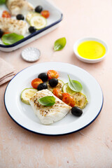 Roasted cod with olives, tomato and zucchini