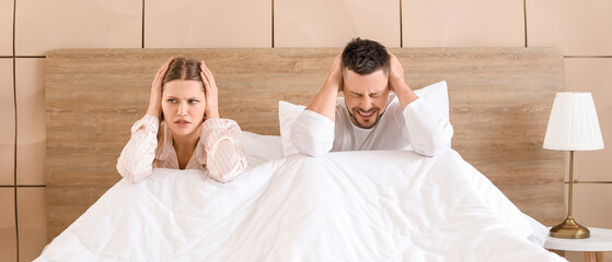 Young couple cannot sleep because of rowdy neighbours