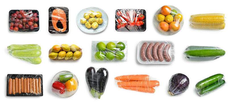 Group of fresh food in plastic wrap on white background