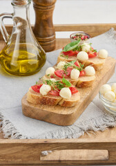 Round mozzarella, cherry tomatoes and microgreens on a piece of white bread, a healthy sandwich